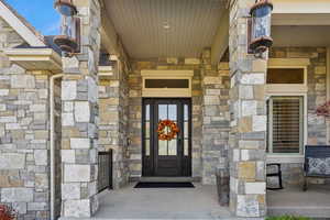 Doorway to property with stone siding