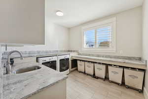 Laundry room featuring washing machine and clothes dryer and wood tiled floors