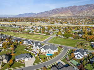 Aerial overview of property's location featuring mountains and nearby suburban area
