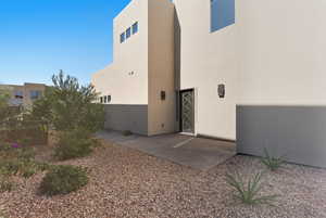 Back of property featuring stucco siding