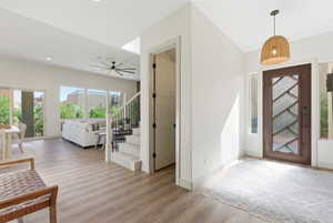 Foyer entrance featuring stairway, light wood finished floors, ceiling fan, and recessed lighting