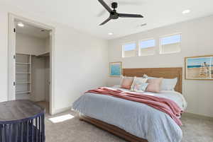 Bedroom with a spacious closet, carpet, a ceiling fan, and recessed lighting