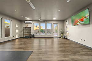 Exercise area featuring recessed lighting, ceiling fan, and a textured ceiling