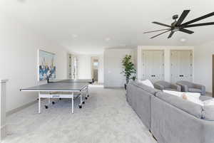 Recreation room featuring light carpet and a ceiling fan