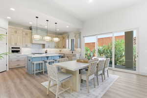 Dining room with light wood-type flooring and recessed lighting