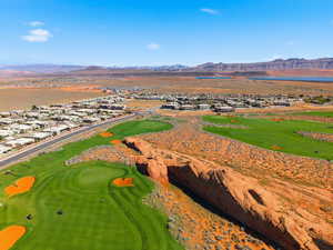 Aerial view of residential area with a mountain backdrop and a local golf course