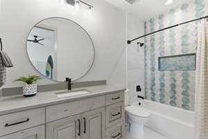 Bathroom with shower / tub combo with curtain, vanity, and light tile patterned floors