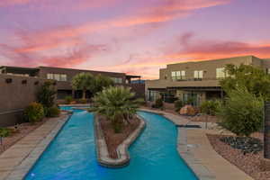 Pool at dusk with a community pool and a patio