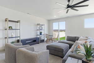 Living area with carpet and a ceiling fan