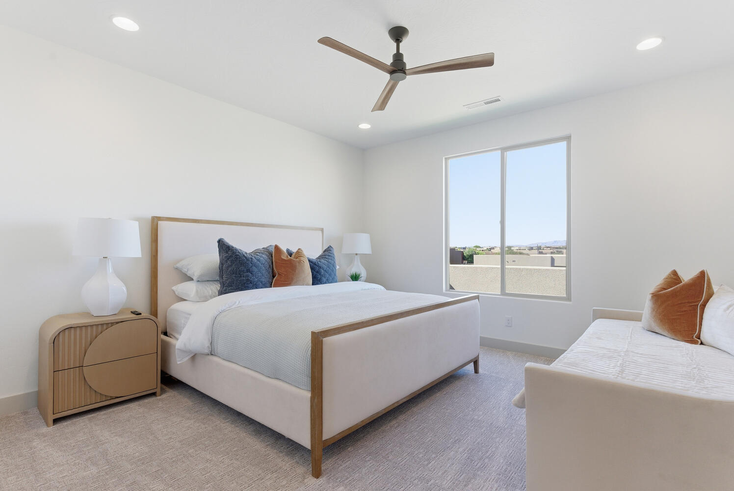 Carpeted bedroom featuring a ceiling fan and recessed lighting