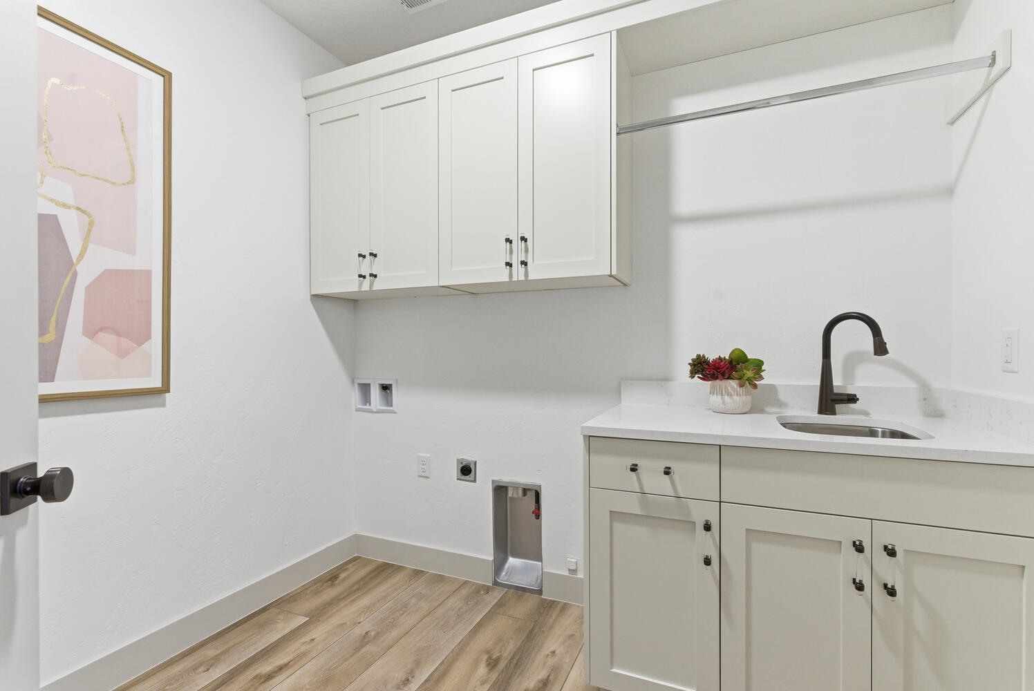 Laundry room with light wood-style floors, washer hookup, electric dryer hookup, and cabinet space