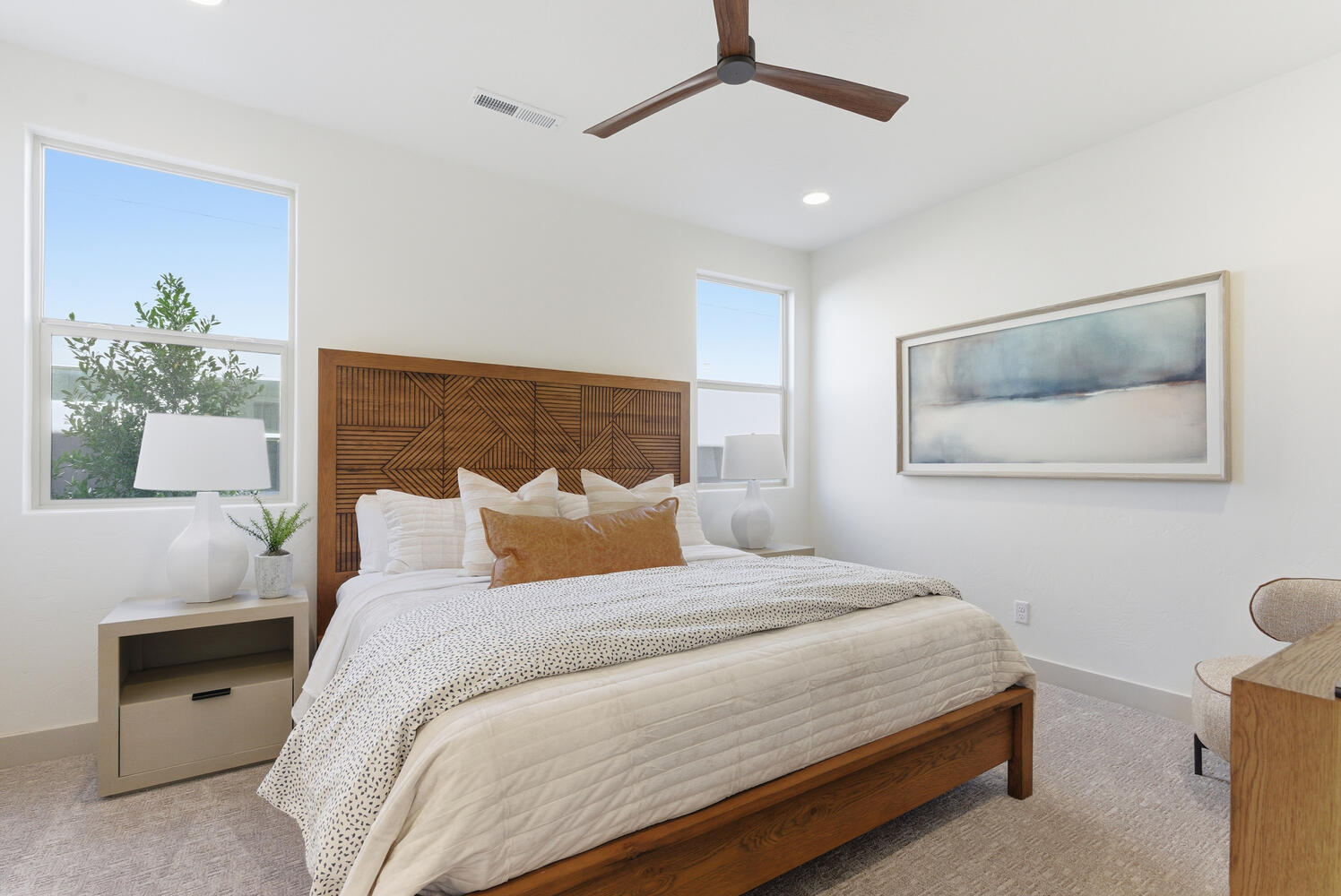 Bedroom with light colored carpet, ceiling fan, and recessed lighting