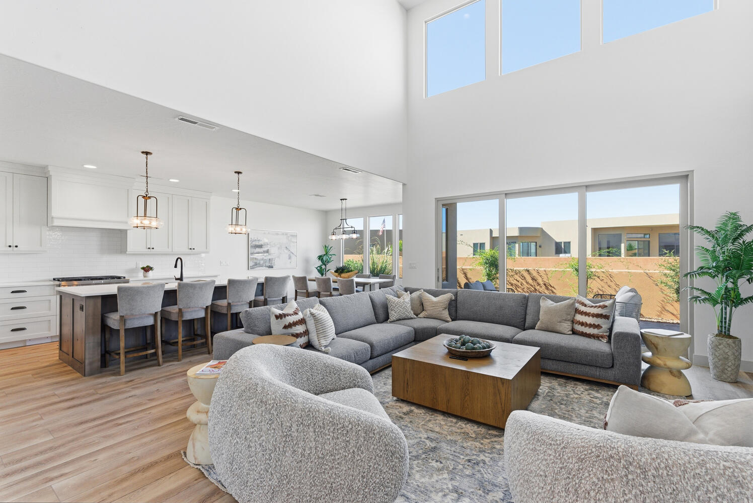 Living room with light wood-style floors and a towering ceiling