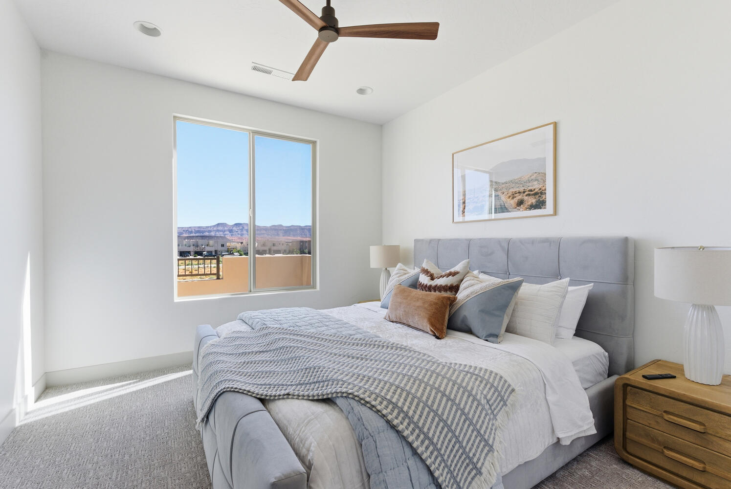 Carpeted bedroom with a ceiling fan and recessed lighting