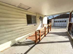 View of patio / terrace featuring an outbuilding and a garage