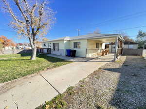 Single story home with an attached carport and driveway