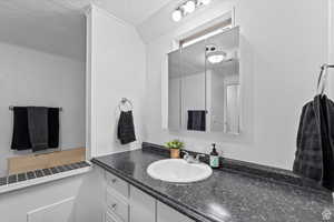 Half bath featuring vanity and a textured ceiling