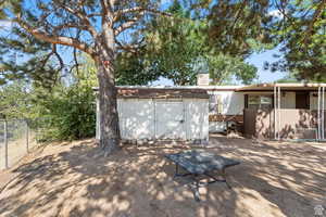 Back of house featuring a storage shed