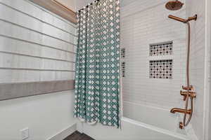 Full bath featuring shower / bath combo