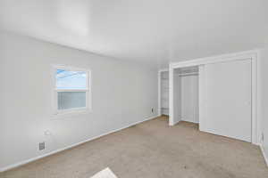 Unfurnished bedroom with carpet flooring and a closet