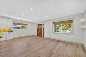 Unfurnished living room with recessed lighting and light wood finished floors