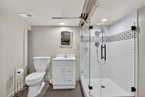 Full bathroom featuring vanity, a stall shower, and recessed lighting