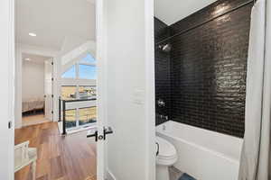 Full bathroom featuring shower / tub combo and light wood finished floors