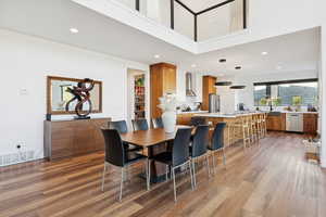 Dining area with recessed lighting and light wood-style floors