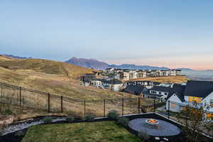 Fenced backyard with a mountain view and an outdoor gas fire pit