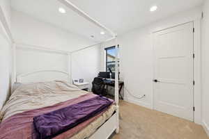 Upstairs Bedroom, #4/8, featuring light colored carpet, and recessed lighting