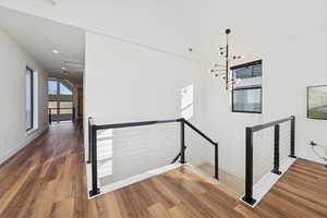 Modern stairway to second floor, chandelier, wood-style floors