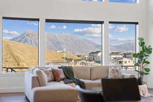Family room featuring wood-style floors, a mountain and residential view