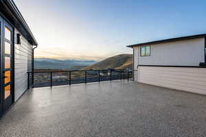 Patio at dusk featuring mountain view and french doors
