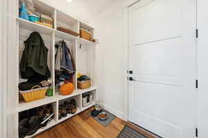 Mudroom with baseboards and wood-style floors