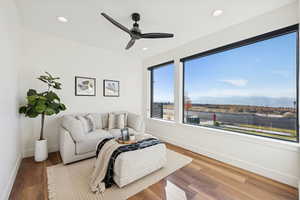 Living area featuring a mountain view, recessed lighting, wood finished floors, and ceiling fan
