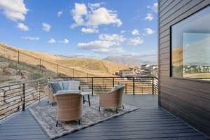 Wood-style deck off kitchen featuring a mountain view