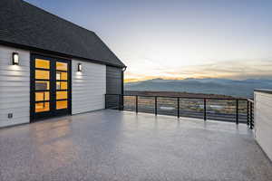 Patio at dusk featuring mountain view and french doors