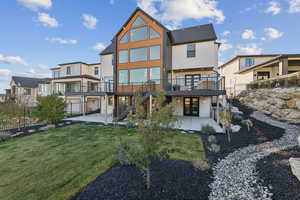 Back of property featuring stairway, a patio, stucco and cedar siding, and a residential view