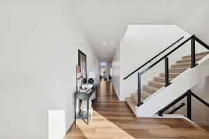 Entryway featuring light wood-style flooring, modern stairway, and recessed lighting