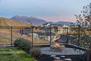 Fenced backyard with a mountain view and an outdoor gas fire pit
