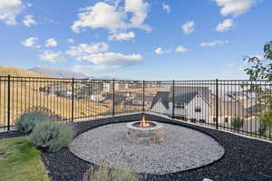 Fenced backyard with a mountain view and an outdoor gas fire pit