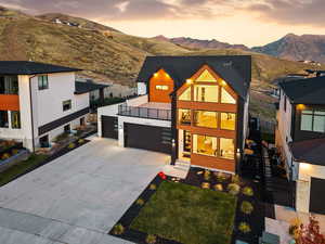 Modern home featuring large upper deck, mountain view, and expansive windows