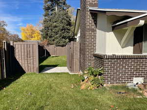 View of home's exterior featuring a chimney and brick siding