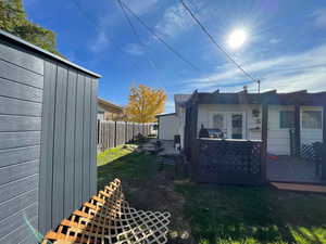 View of side of home with a wooden deck and french doors