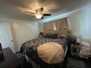 Bedroom featuring a textured ceiling and ceiling fan