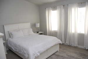 Carpeted bedroom featuring baseboards