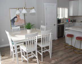 Dining room featuring dark wood-style flooring