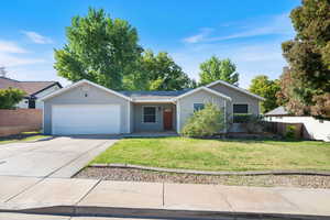 Ranch-style home featuring concrete driveway and a garage