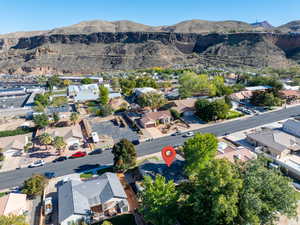 Aerial overview of property's location with mountains and nearby suburban area