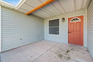 View of exterior entry featuring a patio area